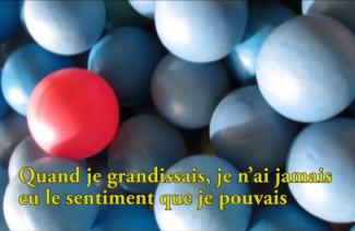 Many blue orbs with a bright red one in the middle.