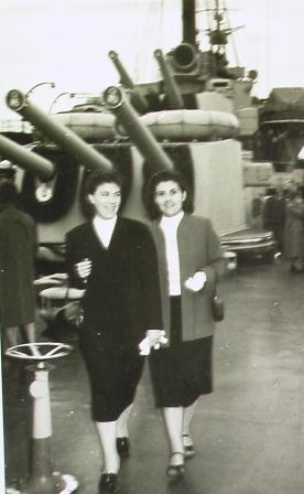 Deux femmes portant des vestes et des jupes, marchant vers l’appareil photo.