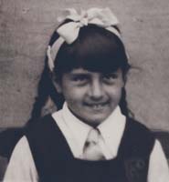 Jeune fille avec grand arc blanc dans les cheveux.